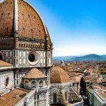 brown-and-white-painted-cathedral-roof-overlooking-city-and-981682
